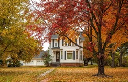 Beautiful house in the autumn garden. Cottage house in beautiful autumn garden