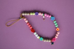 A cute phone charm made with wooden beads and charms. 