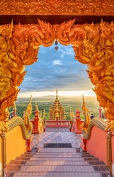 Beautiful golden sunlight shines on the majestic architecture of Wat Phra That Doi Phrachan, Lampang Province, Thailand.