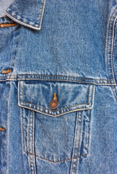 Dark blue jeans texture. Part of the women jeans jacket with pocket close-up.