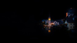 Scenic picture-postcard view of famous Hallstatt mountain village in the Austrian Alps, Salzkammergut region, Hallstatt, Austria. Hallstatt village on Hallstatter lake in Austrian Alps at night.