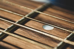 Macro close up shot of acoustic guitar strings on sun shine. Music and guitar playing concept