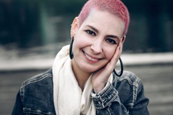 Brazilian hipster girl with beautiful smile and short pink hair. Positive pretty woman outdoors. Portrait