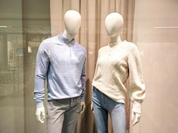 Two mannequins in shop window. Female and male dummies. Family shopping