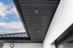 A modern graphite roof lining is attached to the trusses, visible cables and holes for LED lights.