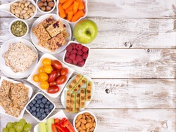 Healthy snacks on wooden table with copy space, top view