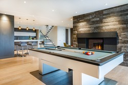 Relaxing with colourful chairs, pool table, fireplace, tv and bar