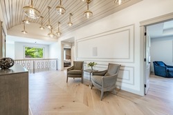 Barrel gallery hall foyer landing with two chairs and large globe pendant light fixtures