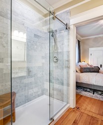 Modern and classic bathroom with glass shower claw footed bath tub and stained glass window