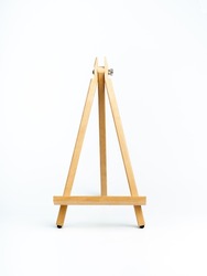Wooden easel isolated on white background, vertical style. Advertising mockup for artboard, pictures, or painting artwork. Easel standing display.