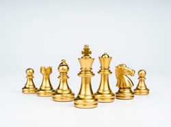 Set of luxury golden chess pieces isolated on white background. The photo of gold chess, king, rook, bishop, queen, knight, and pawn.