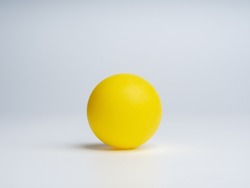 Yellow ball isolated on white background with space for logo templates, icon background, photography studio shot. A clean yellow circle sphere with shadow on the ground.