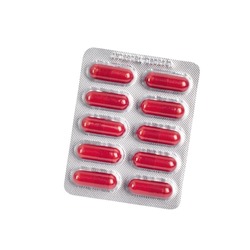 Red pills in a blister pack isolated on white background