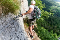 A young male climber on Via Ferati on beautiful European rocks