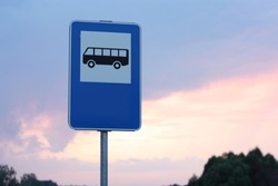 Blue and white bus stop sign in Europe with sky background