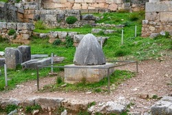 The omphalos, an ancient religious stone artifact marking the center of the world or navel of the Earth according to the ancient Greeks at the Unesco Heritage site at Delphi, Greece.