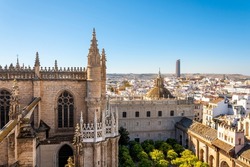 View from the Giralda Tower out over the courtyard of the Seville Cathedral with the city and Sevilla Tower Skyscraper in view.