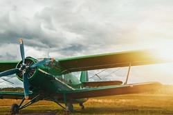 Vintage aircraft preparing for take-off on the background of a stormy sky