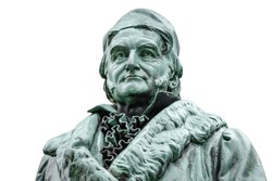 Historic statue of Carl Friedrich Gauss at his birthplace in Braunschweig, Lower Saxony, Germany. Portrait of famous mathematician and physicist (1777-1855), isolated on white background.