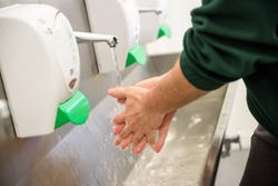Hand Hygiene and Food Safety. Factory worker washing hands. coronavirus protection