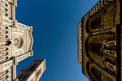 The Florence Cathedral (Duomo di Santa Maria del Fiore), the Giotto's Campanile and Florence Baptistery (Battistero di San Giovanni) facing each other on a sunny day.