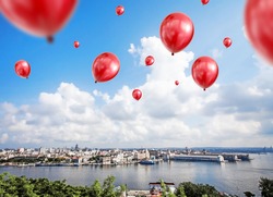 red balloons flying over city