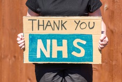 Thank-you NHS Message  written on Cardboard sign.
