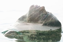 Double exposure portrait of attractive woman combined with photograph of lake surrounded by mountains