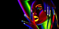 Disco dancer in neon light. Fashion model woman in neon light, portrait of beautiful model girl with fluorescent make-up, Body Art design in UV, painted face, colorful make up, over black background