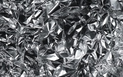 Aluminium foil texture background. Crumpled metal surface close up