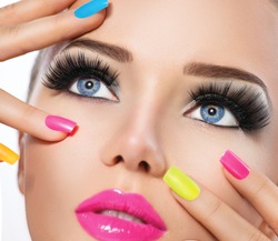 Beauty Girl Portrait with Vivid Makeup and colorful Nail polish. Colourful nails. Fashion Woman portrait close up. Bright Colors. Manicure Make up. Smoky eyes, long eyelashes. Rainbow Colors 
