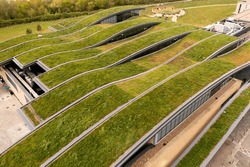 Aerial view of the extensive wildflower green roof or living roof on the net zero rooftop of a green building owned by a responsible business
