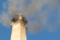 Smoke from the chimney of the crematorium according to the Thai Buddhist tradition