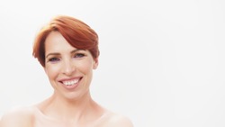 Beauty shot of redhead middle aged woman. Aging process,skin care and cosmetics. High quality photo