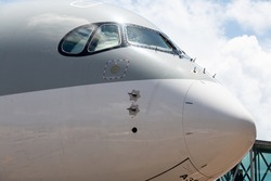 The close up shot of the nose of an Airbus 350-900 during a middle of the day.
