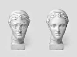 Two marble heads of young women, ancient Greek goddess bust marked with lines for plastic surgery and sculpture after operation on light background. Old and new beauty standarts concept.