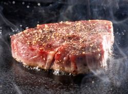 Grilled sirloin steak on hot iron plate
