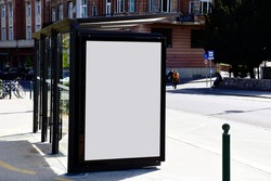 image composite of bus shelter. bus transit stop. blank white lightbox. glass structure. urban setting. city street background. asphalt sidewalk.blank poster ad commercial space. background for mockup