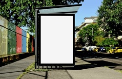 bus shelter at bus stop. blank lightbox billboard ad sign. white ad poster and commercial space. green urban street. display panel. empty vertical outdoor poster space. mockup base  background 