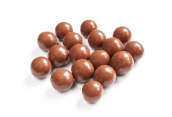 Shiny and smooth chocolate covered balls. Tasty treat isolated on white background