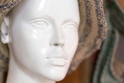 White female mannequin in knitted hat. Head, close-up