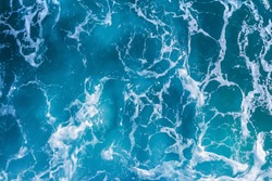 Abstract blue sea water with white foam for background, nature background concept