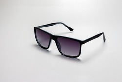 Black sports glasses on white background. Side view. Space for text.