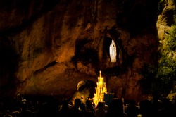 Grotto in Lourdes, France, by night where Bernadette Soubirous saw a vision ot the Virgin Mary in a cave called Massabielle near the Gave river.