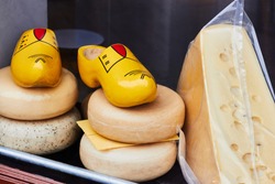 Dutch cheese and traditional wooden shoes clogs in the shop window, Amsterdam, Holland, Netherlands