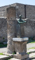 Male bronze bust and column, part of the Pompeii forum.