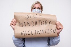 A woman holding a poster, sign No mandatory vaccination, she expresses a protest against forced vaccines, vaccination