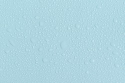 Large and small water drops on the blue background of the mine space. The texture of water drops is a close - up view from above.