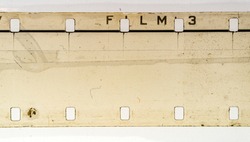 detail macro shot of blank exposed grungy 16mm filmstrip on white background