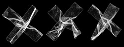 three sets of transparent sticky tapes forming the letter x or overlapping each other on black background, crumpled plastic snips, poster design overlays or elements.